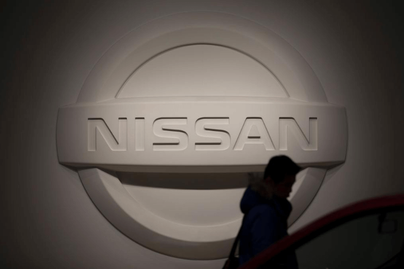  2019年1月7日，在日本橫濱日產汽車公司總部，一名男子從日產標志前經